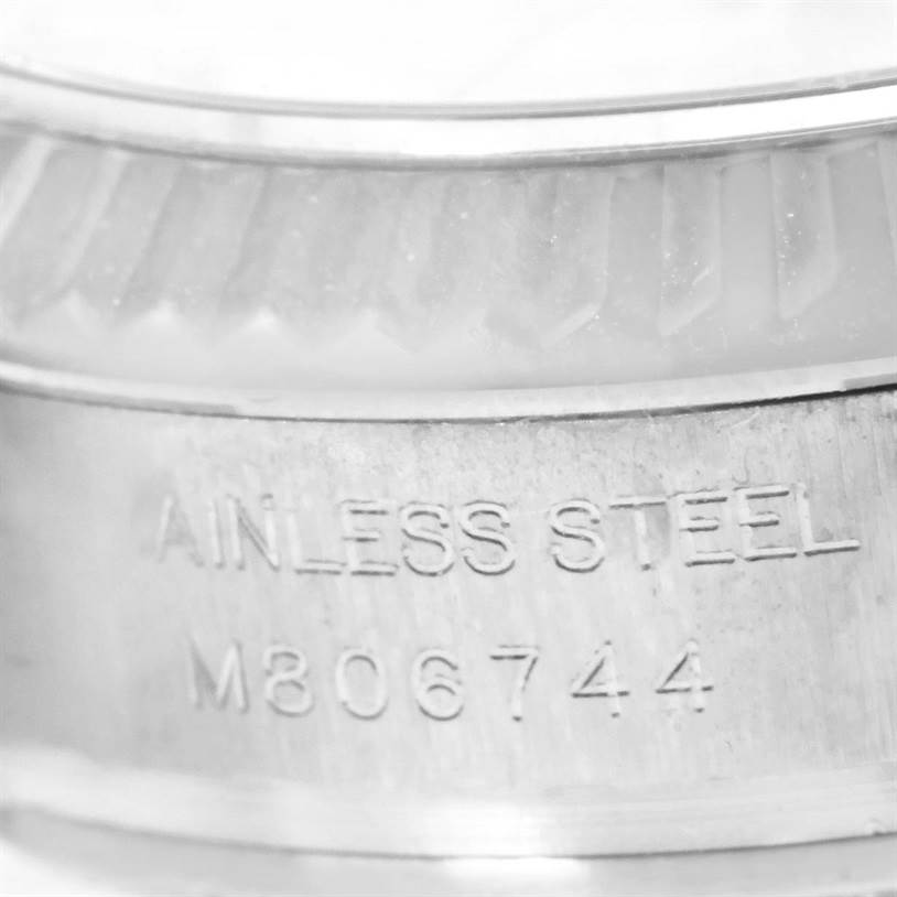 This close-up image shows the engraved "STAINLESS STEEL" marking and serial number on the side of the Rolex Oyster Perpetual 176234 Women
s Stainless Steel Silver Dial 176234 Women
s Stainless Steel Silver Dial watch case.