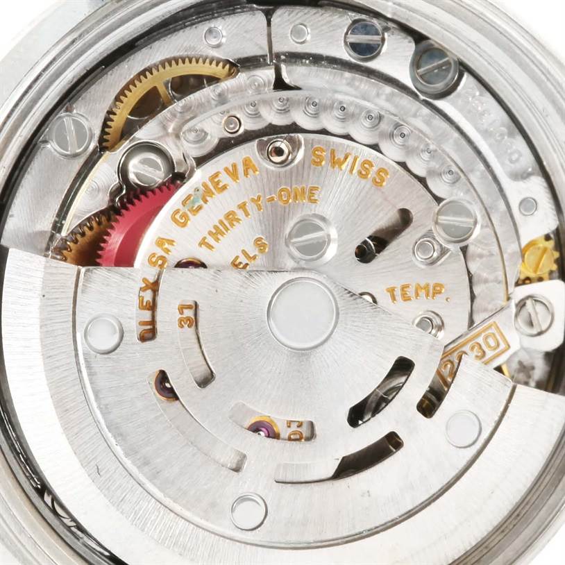 This image shows the intricate internal mechanical movement of a Rolex Oyster Perpetual 76080 Women
s Stainless Steel Silver Dial 76080 Women
s Stainless Steel Silver Dial watch from a close-up angle.