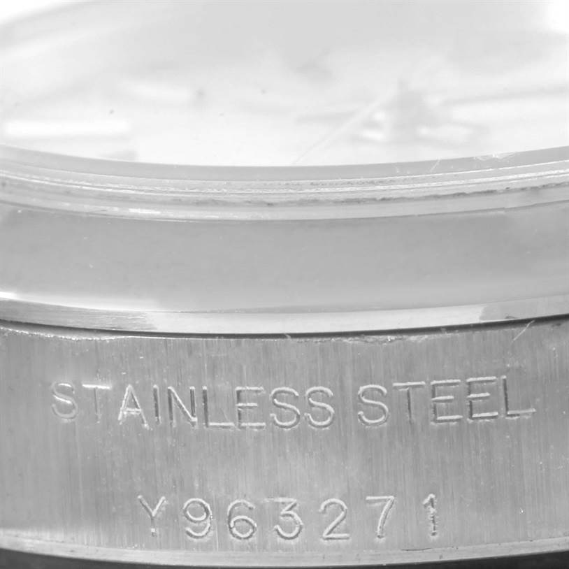 The image shows a close-up of the side of a Rolex Oyster Perpetual 76080 Women
s Stainless Steel Silver Dial 76080 Women
s Stainless Steel Silver Dial watch, focusing on the stainless steel band with a serial number.