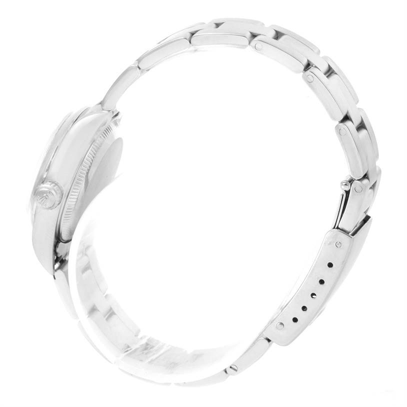 The image shows a side view of a Rolex Oyster Perpetual 76080 Women
s Stainless Steel Silver Dial 76080 Women
s Stainless Steel Silver Dial watch, displaying its case, crown, and metal bracelet.