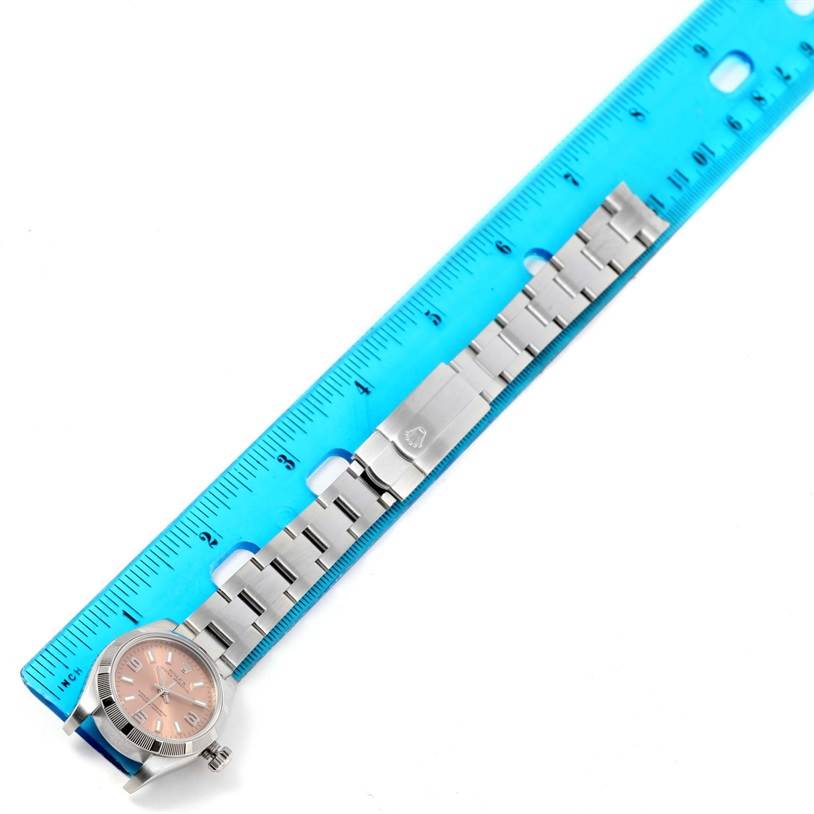 The image shows the face and complete band of a Rolex Oyster Perpetual 176200 Women's Stainless Steel Pink Dial 176200 Women's Stainless Steel Pink Dial watch, placed next to a blue ruler.