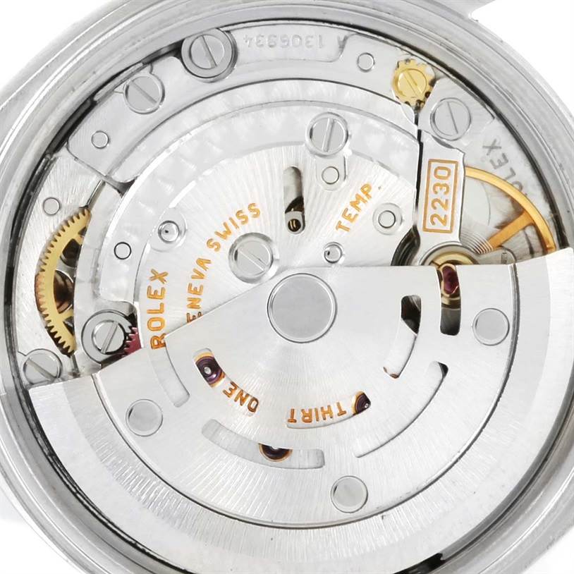 The image shows a close-up of the movement mechanism inside a Rolex Oyster Perpetual 76080 Women's Stainless Steel Pink Dial 76080 Women's Stainless Steel Pink Dial watch, revealing various gears and components.
