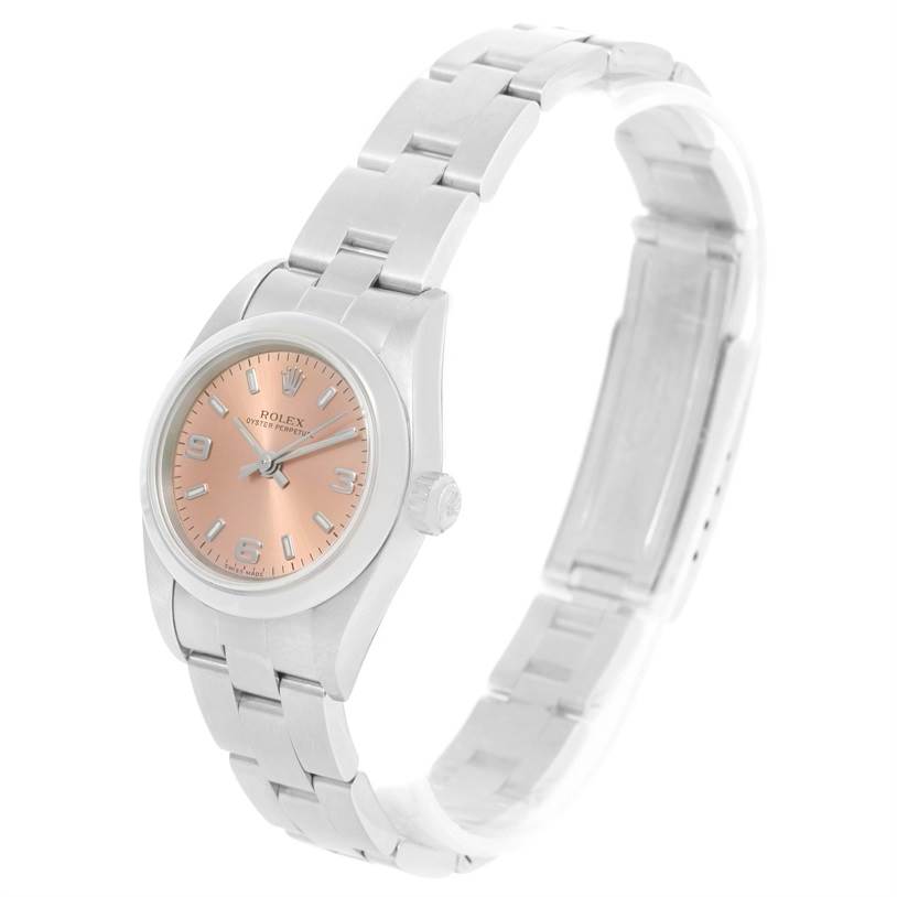 The Rolex Oyster Perpetual 76080 Women's Stainless Steel Pink Dial 76080 Women's Stainless Steel Pink Dial watch is shown at a slight angle, highlighting its bracelet, case, and peach dial.