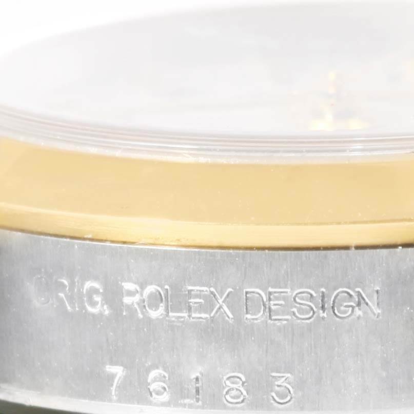 This close-up angle shows the side of a Rolex Oyster Perpetual 76183 Women's Steel and Gold (two tone) White Dial 76183 Women's Steel and Gold (two tone) White Dial watch, highlighting the "ORIG. ROLEX DESIGN" engraving and model number 76183.
