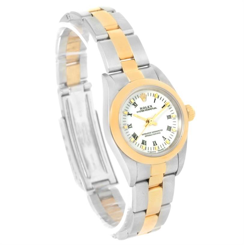This Rolex Oyster Perpetual 76183 Women's Steel and Gold (two tone) White Dial 76183 Women's Steel and Gold (two tone) White Dial watch is shown from a side angle, displaying the bracelet, dial, and crown.