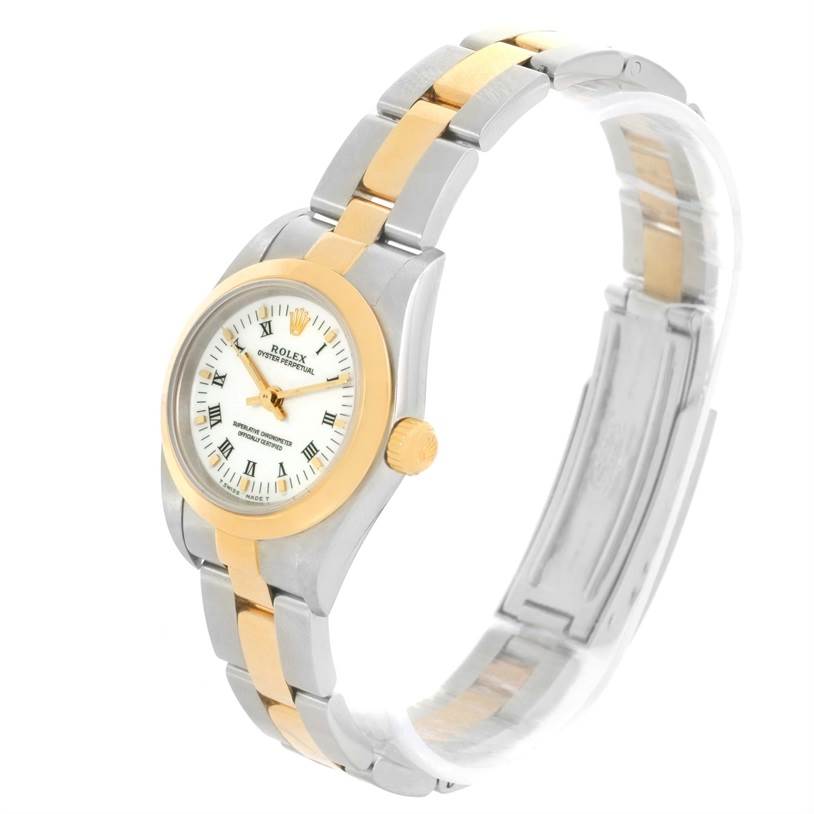 The image shows a side-angled view of a Rolex Oyster Perpetual 76183 Women's Steel and Gold (two tone) White Dial 76183 Women's Steel and Gold (two tone) White Dial watch, highlighting the watch face, bezel, and bracelet.