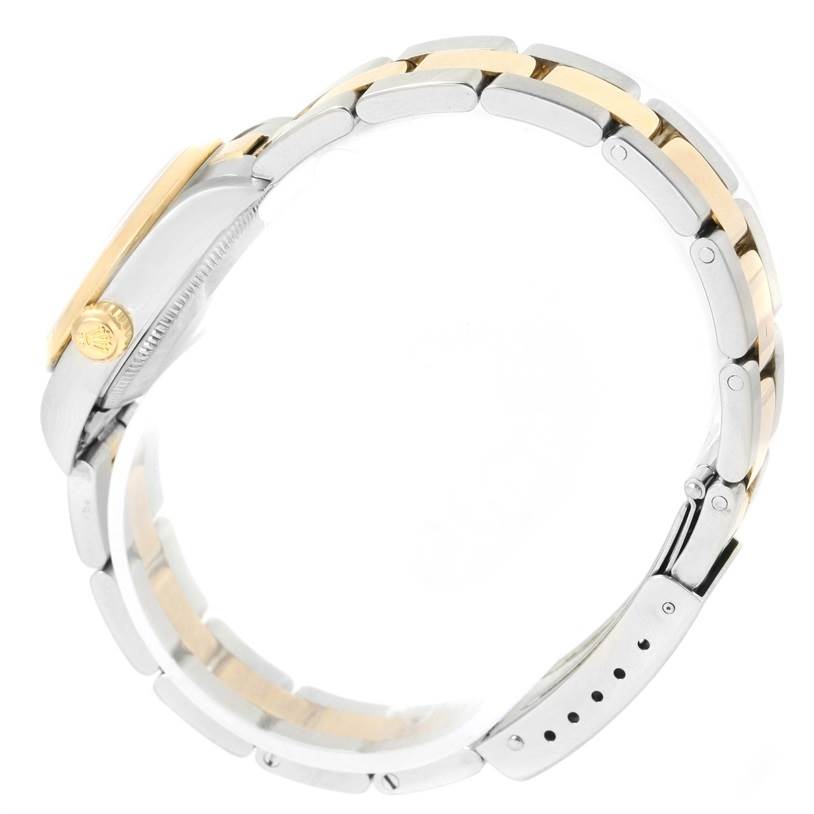 This image shows the side view of the Rolex Oyster Perpetual 76183 Women's Steel and Gold (two tone) White Dial 76183 Women's Steel and Gold (two tone) White Dial watch, highlighting its bracelet and crown.