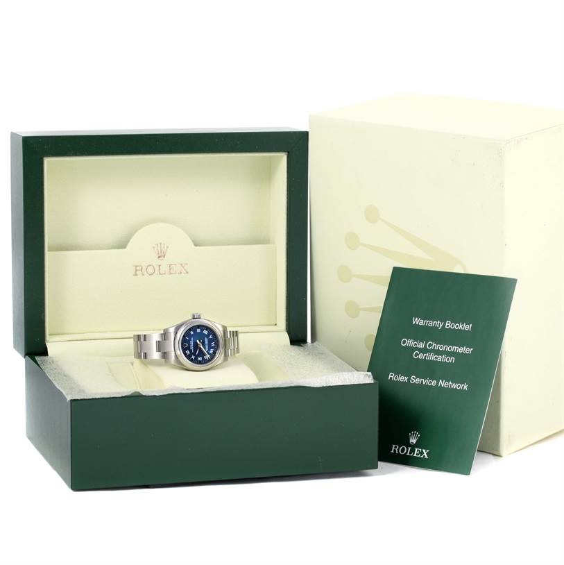 The image shows a Rolex Oyster Perpetual 176200 Women's Stainless Steel Blue Dial 176200 Women's Stainless Steel Blue Dial watch in its open box with a warranty booklet and an outer box adjacent.