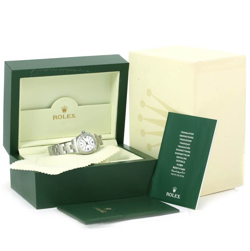 The image shows a Rolex Oyster Perpetual 176210 Women
s Stainless Steel White Dial 176210 Women
s Stainless Steel White Dial watch in its green box with additional accessories and manuals.