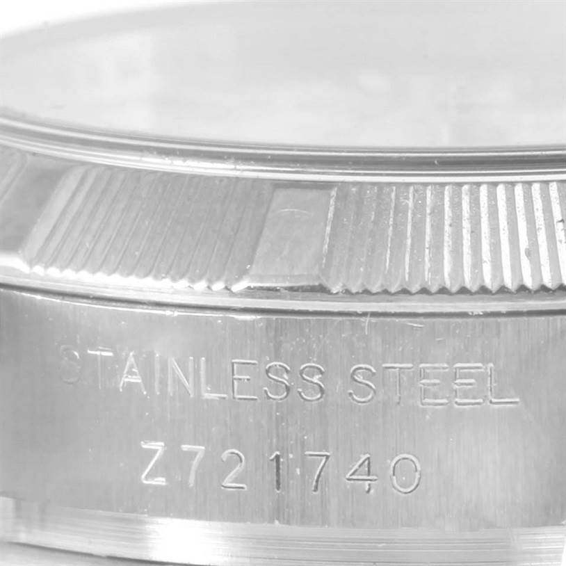 This close-up image of a Rolex Oyster Perpetual 176210 Women
s Stainless Steel White Dial 176210 Women
s Stainless Steel White Dial watch shows the side, highlighting the stainless steel case and serial number.