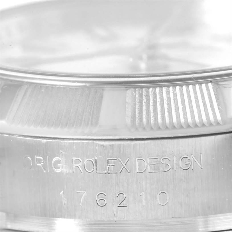 This close-up image of a Rolex Oyster Perpetual 176210 Women
s Stainless Steel White Dial 176210 Women
s Stainless Steel White Dial watch shows the case with model number 176210 and the engraved text "ORIG. ROLEX DESIGN".