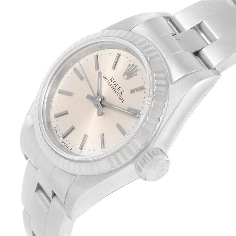 This image shows the watch face, crown, and part of the bracelet of a Rolex Oyster Perpetual 67194 Women's Stainless Steel Silver Dial 67194 Women's Stainless Steel Silver Dial model at a slight angle.