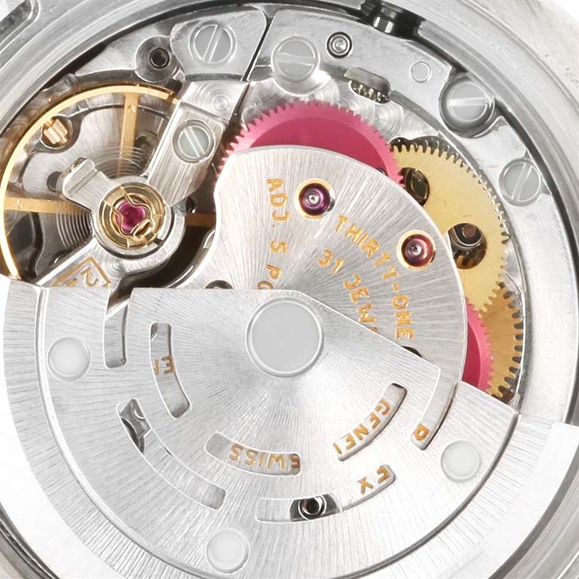 This close-up image of a Rolex Oyster Perpetual 176200 Women's Stainless Steel Black Dial 176200 Women's Stainless Steel Black Dial model showcases its intricate internal movement, including gears and jewels.