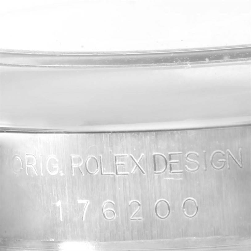 This close-up image shows the side of the case of a Rolex Oyster Perpetual 176200 Women's Stainless Steel Black Dial 176200 Women's Stainless Steel Black Dial, emphasizing the engraved design and model number.