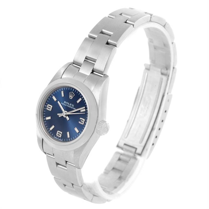 The image shows a Rolex Oyster Perpetual 76080 Women
s Stainless Steel Blue Dial 76080 Women
s Stainless Steel Blue Dial watch, featuring its blue dial, bracelet, and side view of the crown.