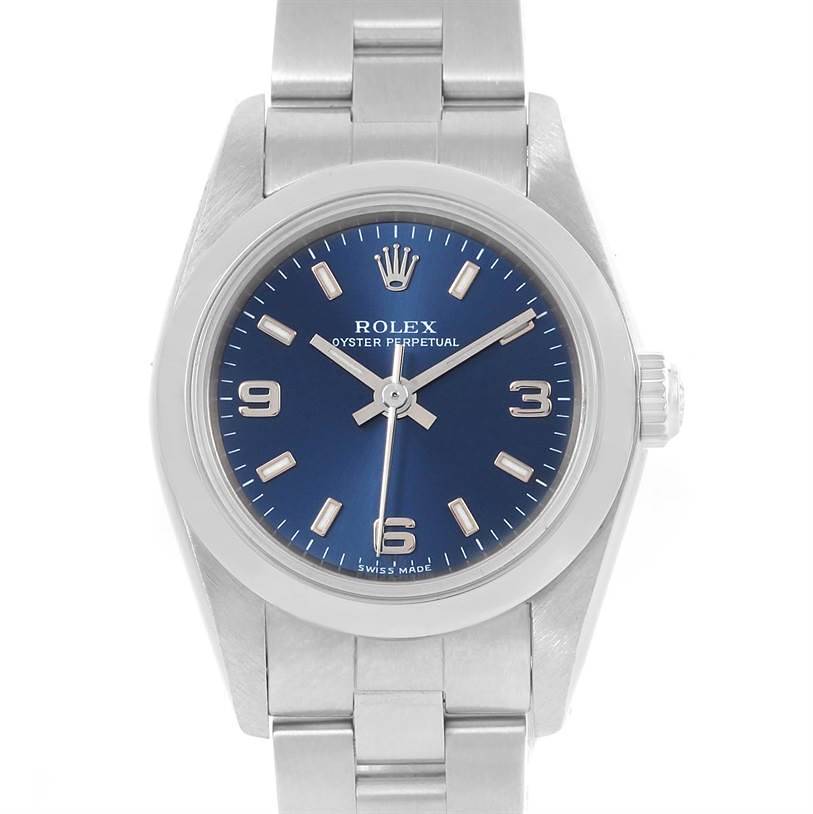 This image shows a Rolex Oyster Perpetual watch from a front angle, highlighting its blue dial, indices, and bracelet.