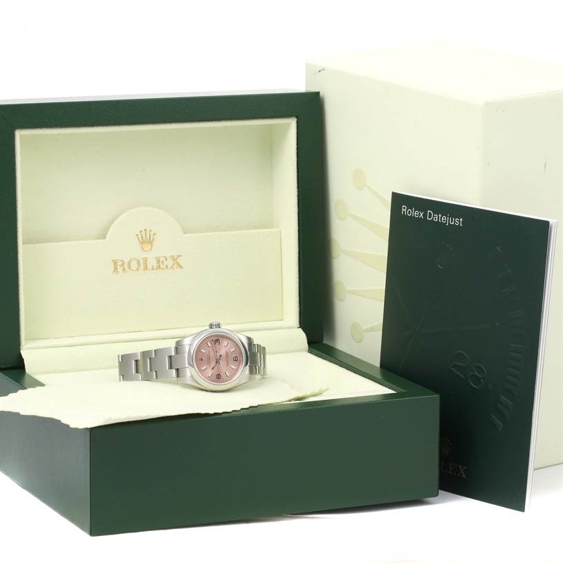 The image shows a Rolex Oyster Perpetual 176200 Women's Stainless Steel Pink Dial 176200 Women's Stainless Steel Pink Dial watch in its box, along with a Rolex Datejust manual.