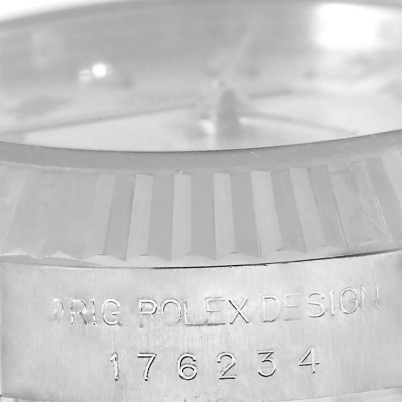The image shows a close-up of the bezel and partially the bezel edge of a Rolex Oyster Perpetual 176234 Women's Stainless Steel Grey Dial 176234 Women's Stainless Steel Grey Dial, with engraved text and numbers on the case.