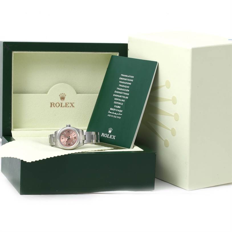 The image shows a Rolex Oyster Perpetual 176200 Men's Stainless Steel Pink Dial 176200 Men's Stainless Steel Pink Dial watch inside its box, with its documentation booklet placed beside it.