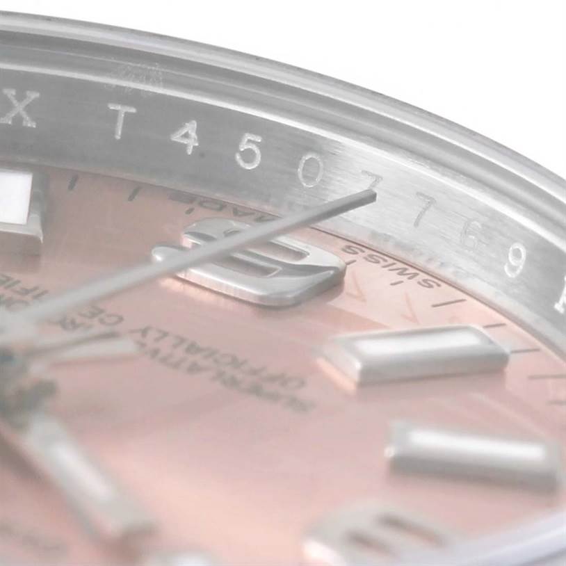 This close-up image shows the dial and partial bezel of the Rolex Oyster Perpetual 176200 Men's Stainless Steel Pink Dial 176200 Men's Stainless Steel Pink Dial watch, highlighting the indices and part of the serial number.