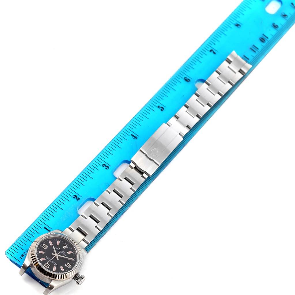 The image shows a Rolex Oyster Perpetual 176234 Women
s Stainless Steel Black Dial 176234 Women
s Stainless Steel Black Dial watch lying flat next to a ruler for size measurement.