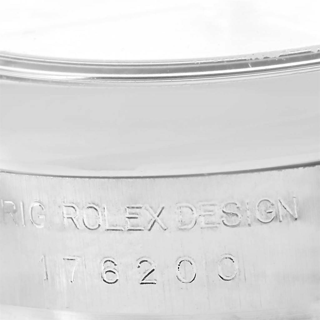 This image shows a close-up view of the engraved serial number on the case of a Rolex Oyster Perpetual 176200 Women's Stainless Steel Pink Dial 176200 Women's Stainless Steel Pink Dial watch.