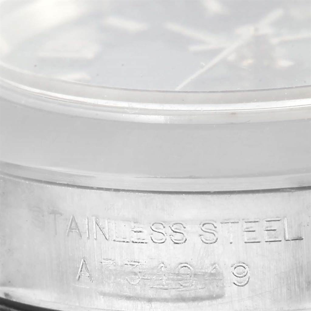 This image shows a close-up of the side of a Rolex Oyster Perpetual 76080 Women
s Stainless Steel Blue Dial 76080 Women
s Stainless Steel Blue Dial watch, focusing on the stainless steel case and engraving.