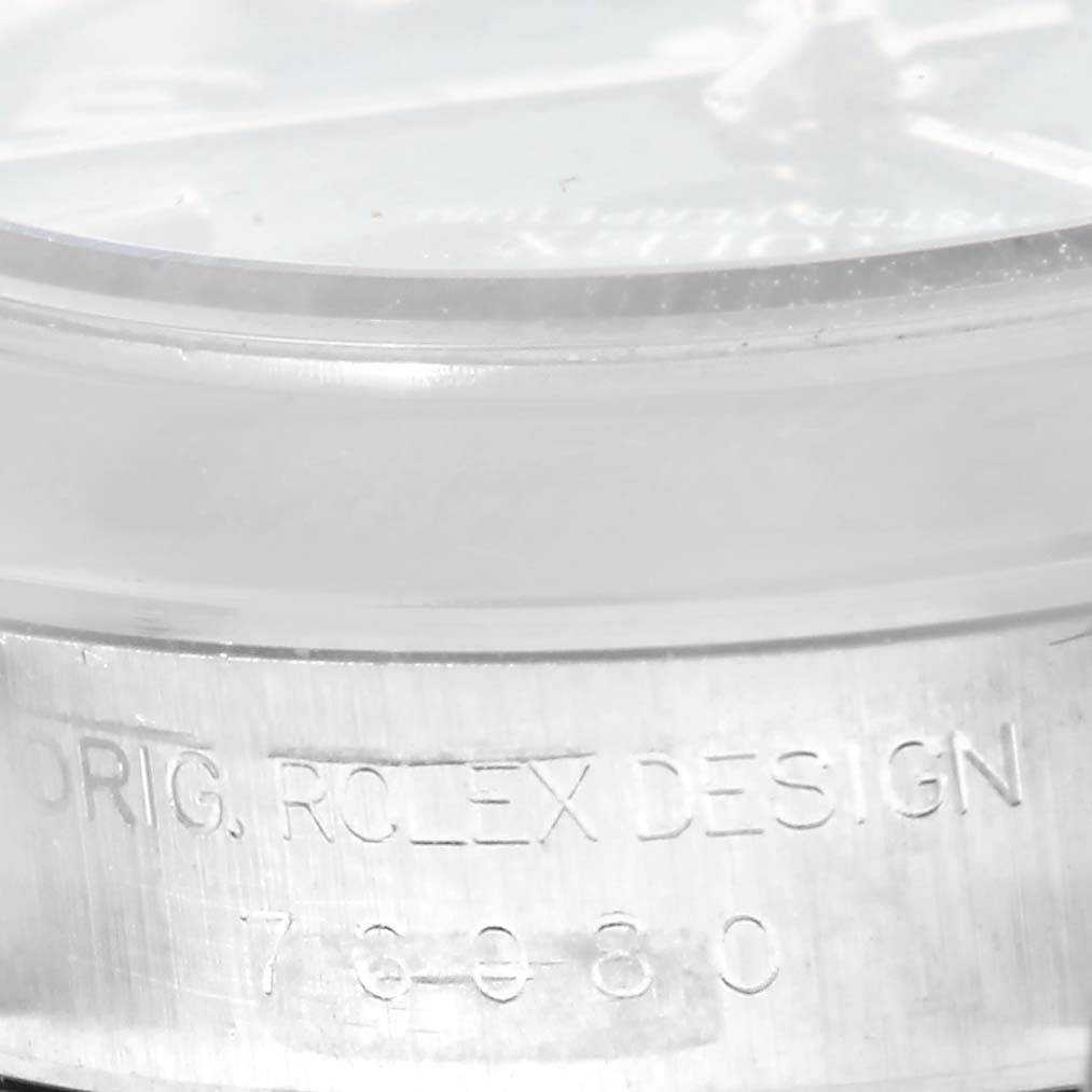 The image shows a close-up of the case side and bezel of a Rolex Oyster Perpetual 76080 Women
s Stainless Steel Blue Dial 76080 Women
s Stainless Steel Blue Dial watch, highlighting the engraved model number.