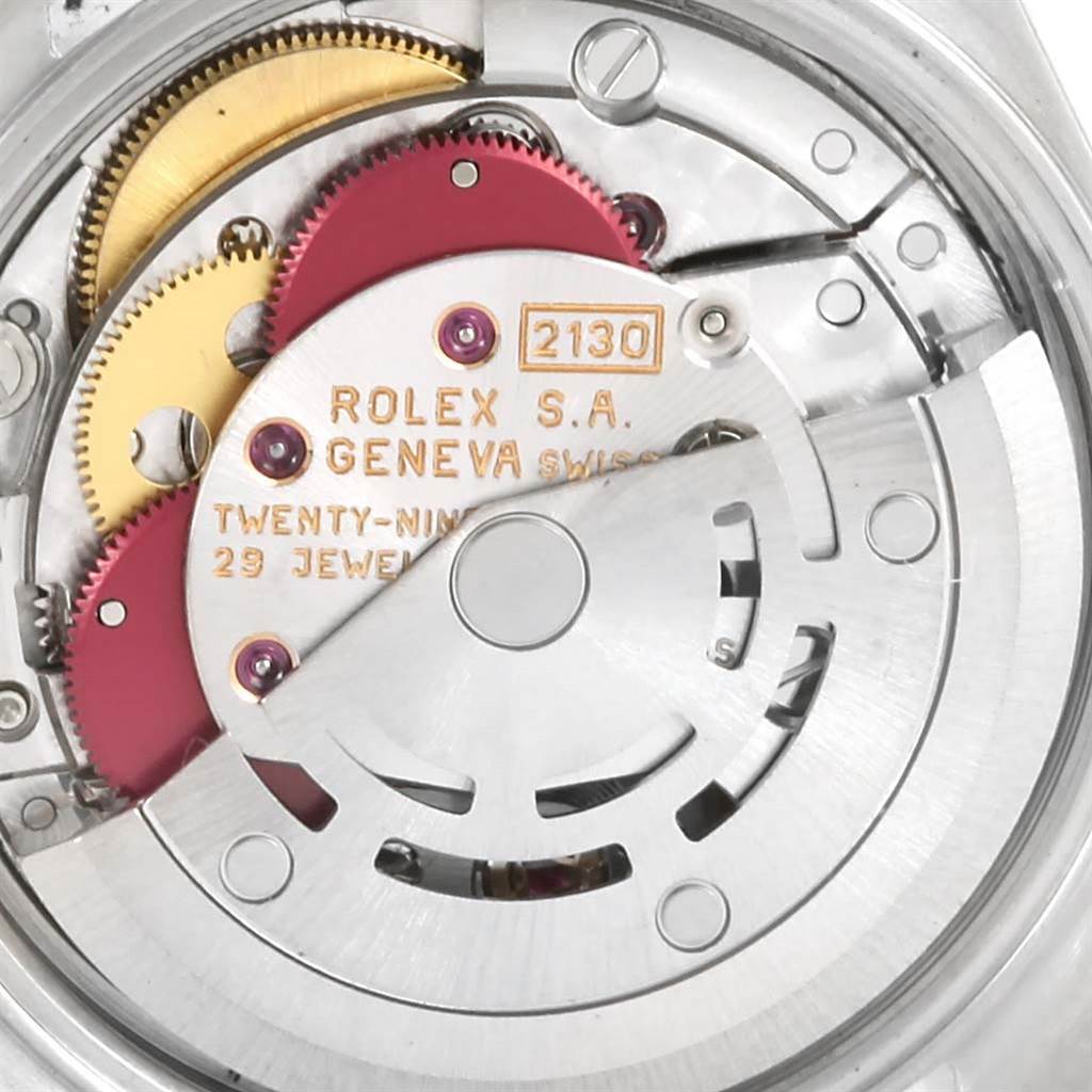 The image shows a close-up view of the internal mechanism of a Rolex Oyster Perpetual 67194 Women's Stainless Steel White Dial 67194 Women's Stainless Steel White Dial watch, focusing on its gears and rotor.