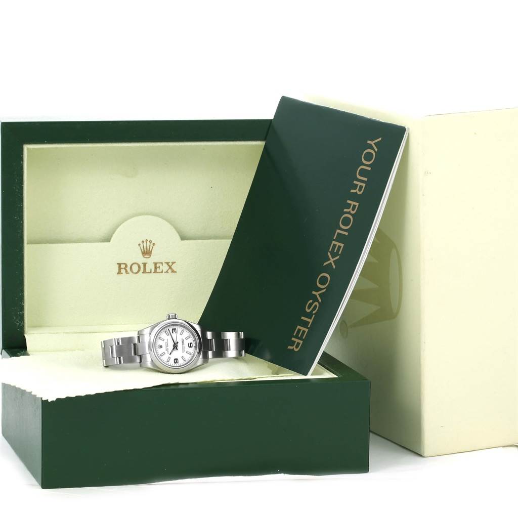The image shows a Rolex Oyster Perpetual 176200 Women
s Stainless Steel White Dial 176200 Women
s Stainless Steel White Dial watch placed in its open green box with an accompanying booklet stating "Your Rolex Oyster."
