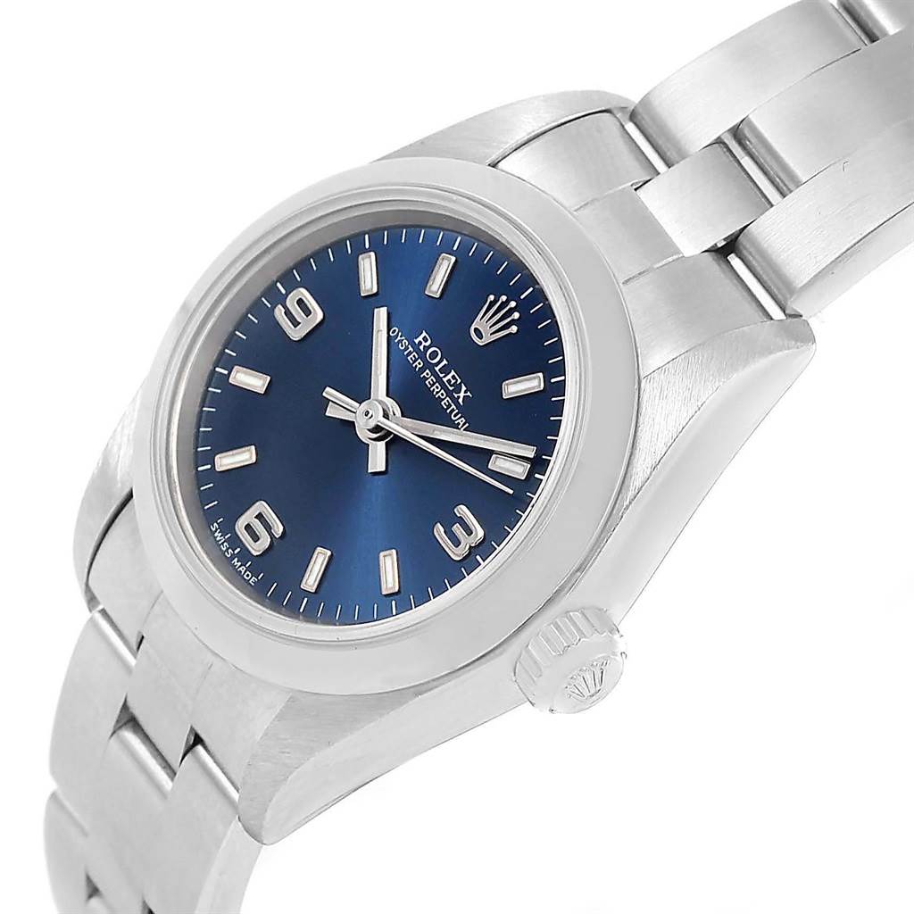 The Rolex Oyster Perpetual 67180 Men
s Stainless Steel Blue Dial 67180 Men
s Stainless Steel Blue Dial watch is shown from an angled side view highlighting the face, bezel, crown, and part of the bracelet.