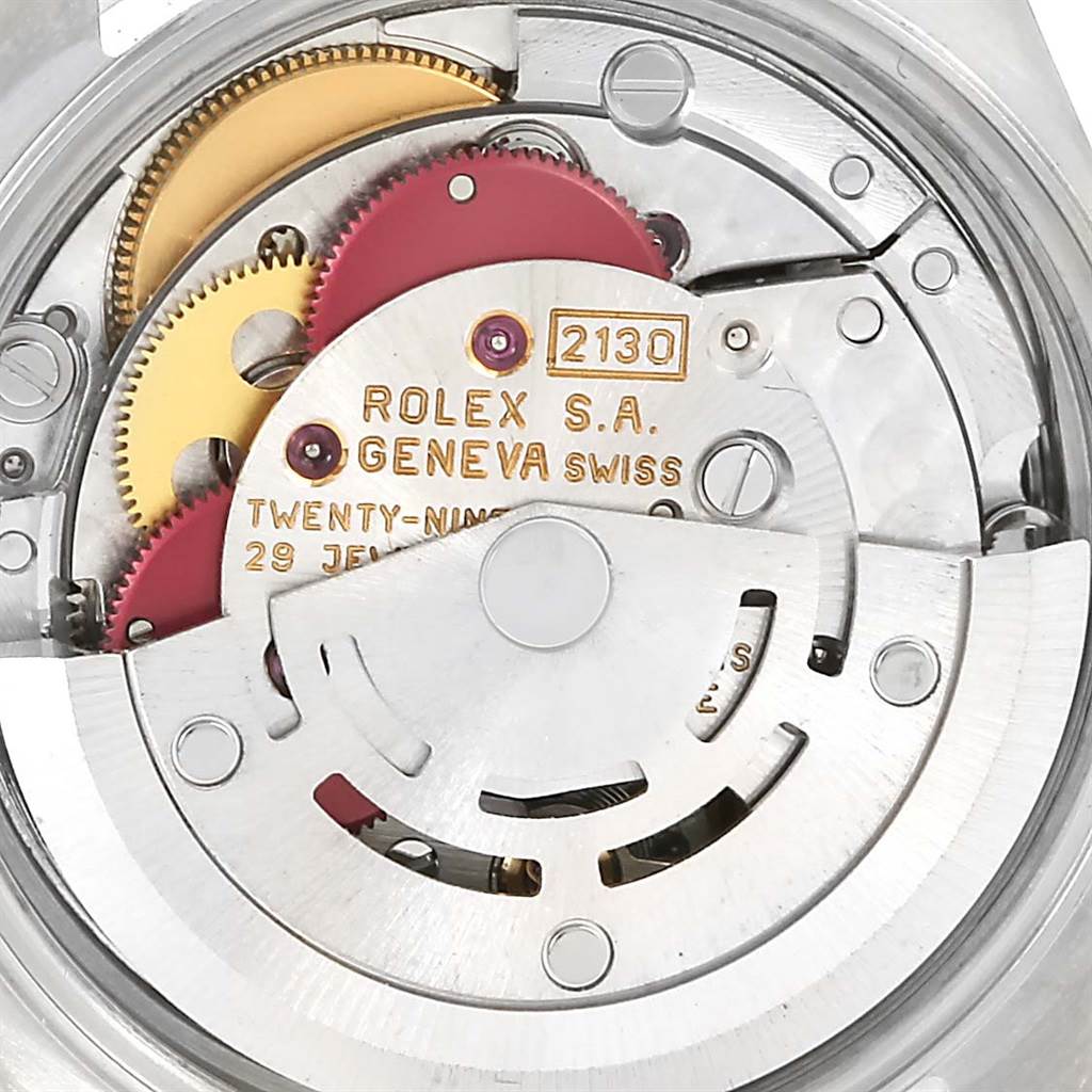 This image shows the inner mechanism and components of the Rolex Oyster Perpetual 67180 Men
s Stainless Steel Blue Dial 67180 Men
s Stainless Steel Blue Dial watch, highlighting its intricate gears and markers.