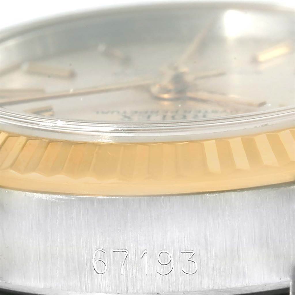 The close-up angle of this Rolex Oyster Perpetual 67193 Women's Steel and Gold (two tone) Silver Dial 67193 Women's Steel and Gold (two tone) Silver Dial watch shows the fluted bezel, part of the dial, and the model number "67193".