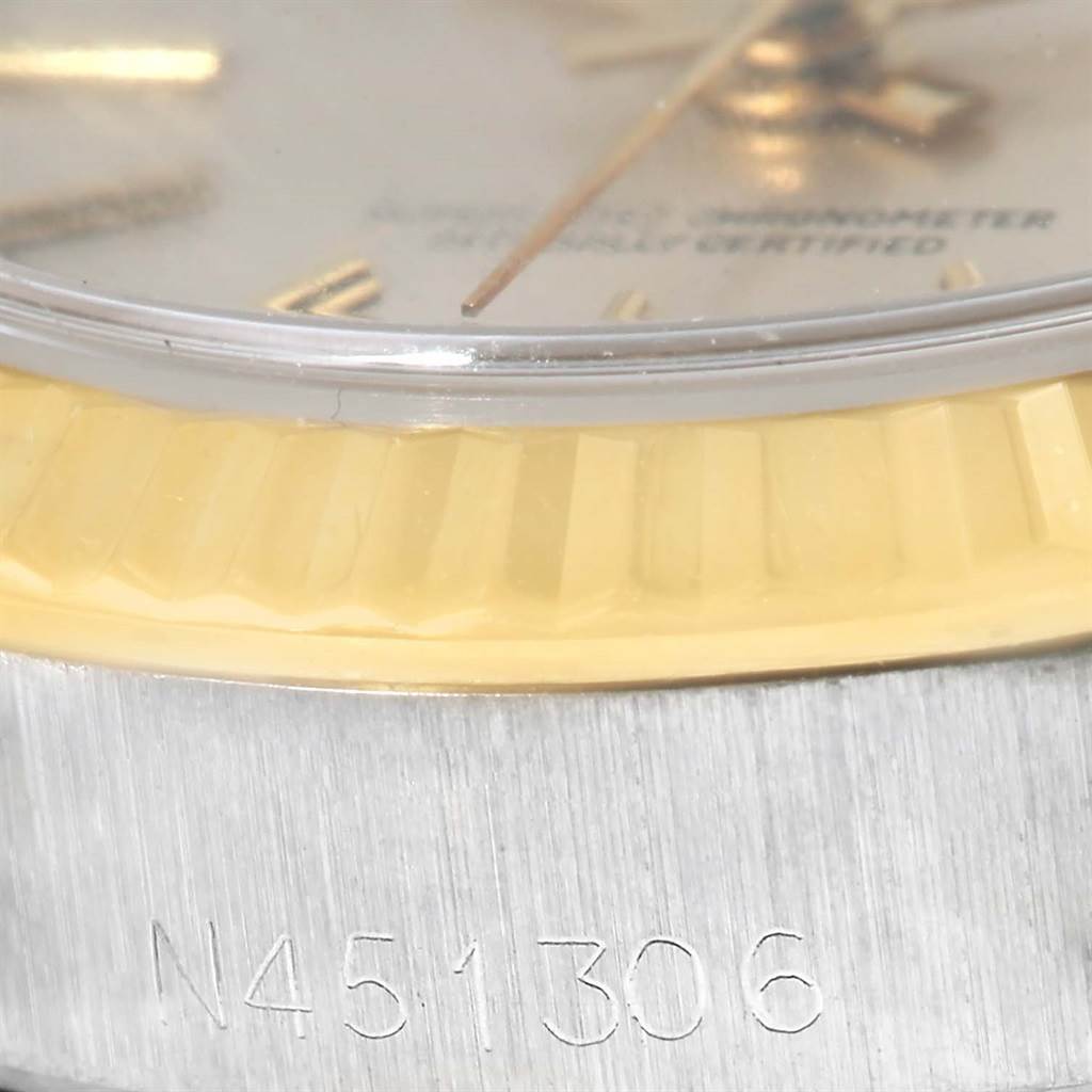 The image shows a close-up of the serial number engraving and part of the bezel and dial of a Rolex Oyster Perpetual 67193 Women's Steel and Gold (two tone) Silver Dial 67193 Women's Steel and Gold (two tone) Silver Dial watch.