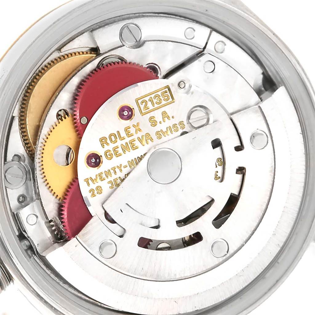 This is a close-up view of the internal mechanism of a Rolex Oyster Perpetual 67193 Women's Steel and Gold (two tone) Silver Dial 67193 Women's Steel and Gold (two tone) Silver Dial watch, showing gears and component parts.