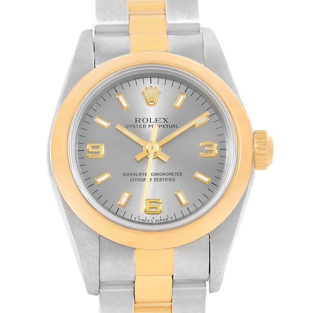 The Rolex Oyster Perpetual 76183 Women's Steel and Gold (two tone) Grey Dial 76183 Women's Steel and Gold (two tone) Grey Dial watch is shown from a front angle, displaying the face, bezel, and part of the bracelet.