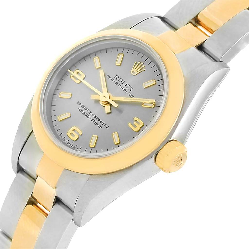 This image shows a close-up angle of the dial, bezel, crown, and bracelet of a Rolex Oyster Perpetual 76183 Women's Steel and Gold (two tone) Grey Dial 76183 Women's Steel and Gold (two tone) Grey Dial watch.