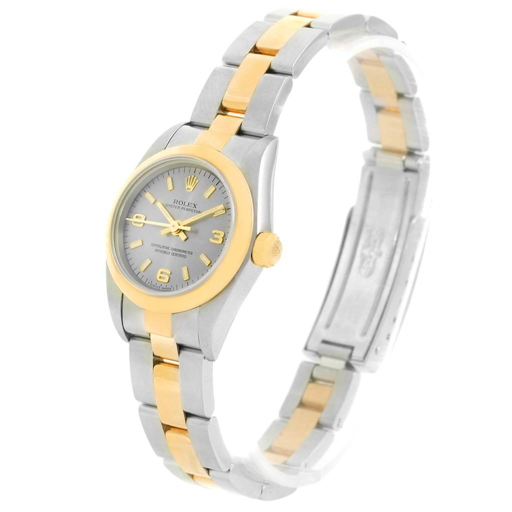 The Rolex Oyster Perpetual 76183 Women's Steel and Gold (two tone) Grey Dial 76183 Women's Steel and Gold (two tone) Grey Dial watch is shown at an angle highlighting its dial, bezel, crown, and two-tone bracelet.