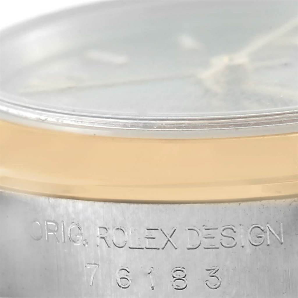 The image shows a side view of the case and bezel of a Rolex Oyster Perpetual 76183 Women's Steel and Gold (two tone) Grey Dial 76183 Women's Steel and Gold (two tone) Grey Dial, highlighting the engraved model number "76183".