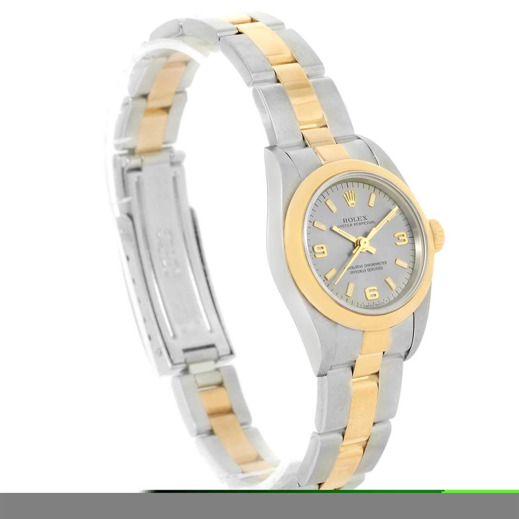 The image shows a side and front angled view of a Rolex Oyster Perpetual 76183 Women's Steel and Gold (two tone) Grey Dial 76183 Women's Steel and Gold (two tone) Grey Dial watch, highlighting its dial, bezel, and bracelet.