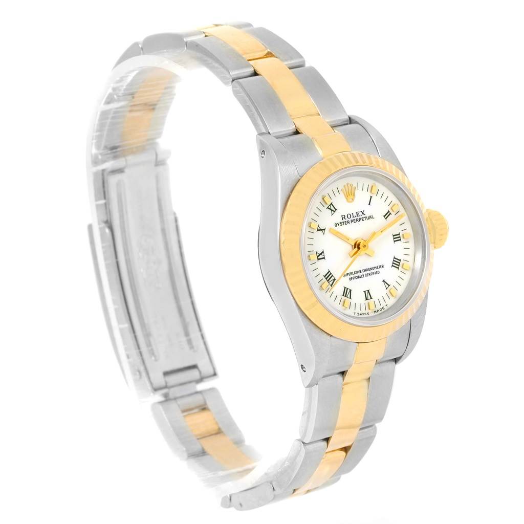 This image shows a side angle view of a Rolex Oyster Perpetual 67193 Women's Steel and Gold (two tone) White Dial 67193 Women's Steel and Gold (two tone) White Dial watch, highlighting its bezel, dial, case, and bracelet.