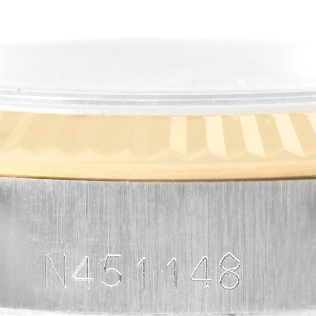 This image shows a close-up of the case edge and the fluted bezel with part of the crystal for the Rolex Oyster Perpetual 67193 Women's Steel and Gold (two tone) White Dial 67193 Women's Steel and Gold (two tone) White Dial watch.