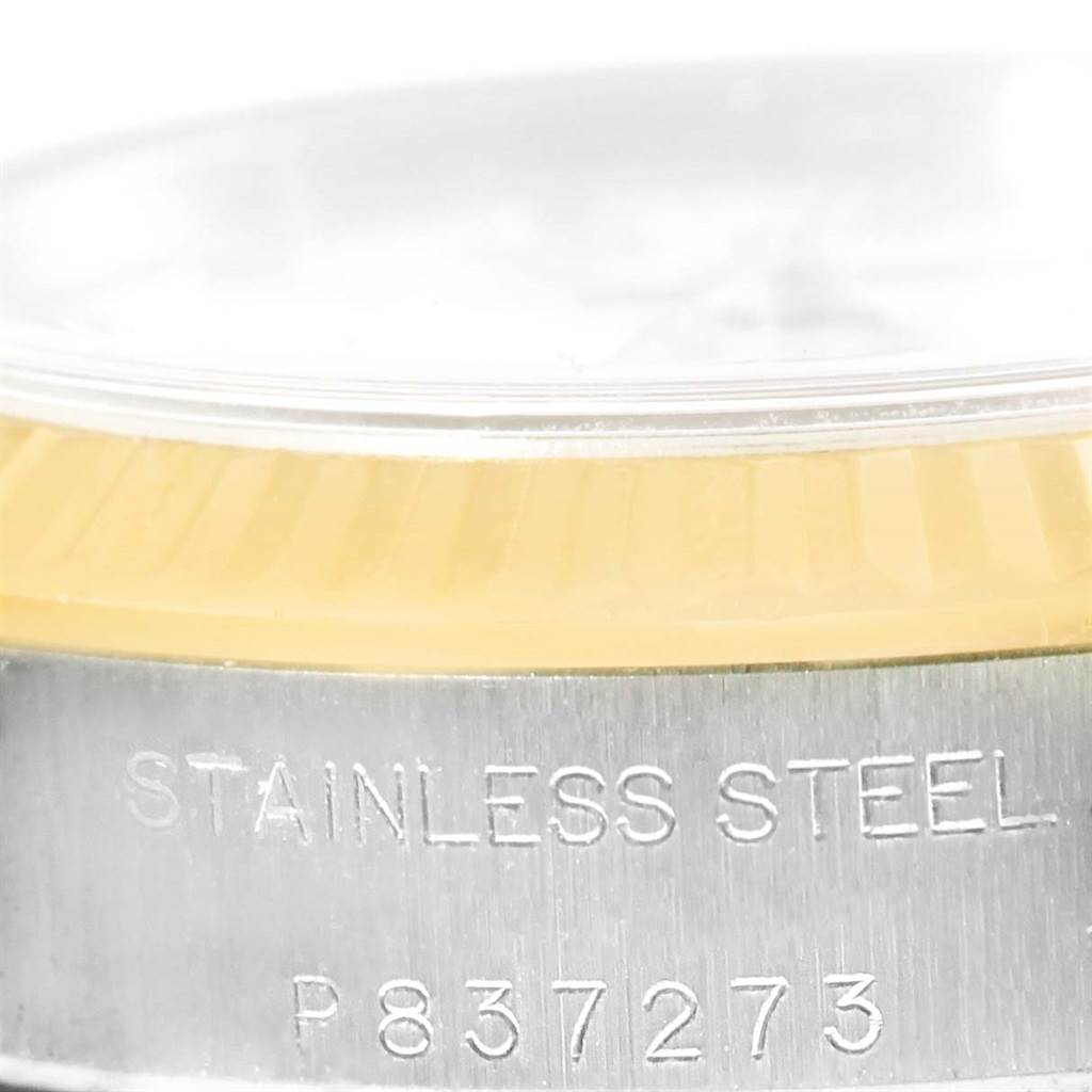 This close-up image features the side of the bezel and the stainless steel case back of a Rolex Oyster Perpetual 76193 Women's Steel and Gold (two tone) White Dial 76193 Women's Steel and Gold (two tone) White Dial watch, including a visible serial number.