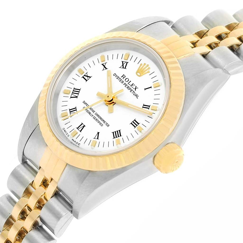 This Rolex Oyster Perpetual 76193 Women's Steel and Gold (two tone) White Dial 76193 Women's Steel and Gold (two tone) White Dial watch is shown at an angled close-up, highlighting the gold bezel, crown, and part of the bracelet.
