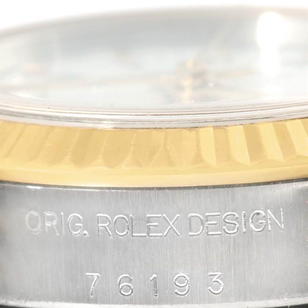 The image shows a close-up of a Rolex Oyster Perpetual 76193 Women's Steel and Gold (two tone) White Dial 76193 Women's Steel and Gold (two tone) White Dial watch, focusing on the bezel with "ORIG. ROLEX DESIGN" and model number 76193 engraved.