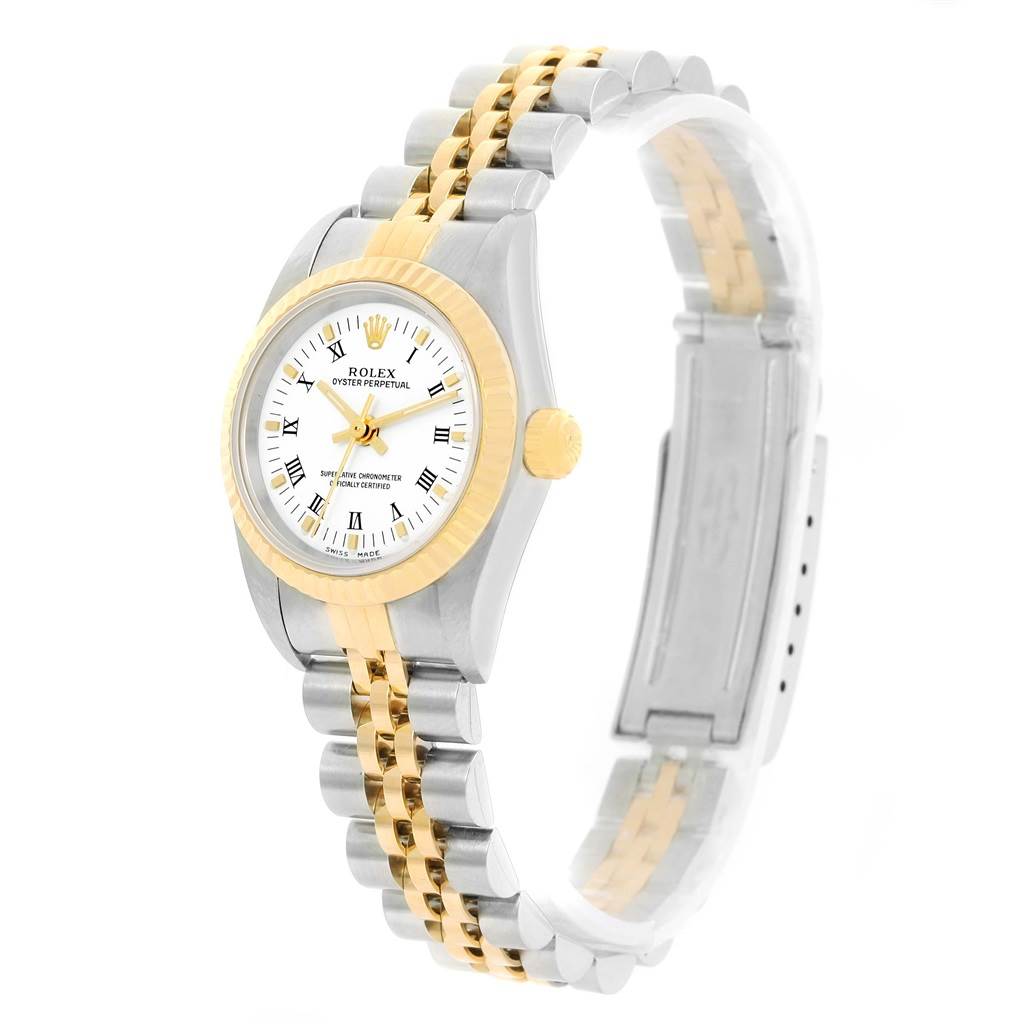 The image shows a side angle of a Rolex Oyster Perpetual 76193 Women's Steel and Gold (two tone) White Dial 76193 Women's Steel and Gold (two tone) White Dial watch, highlighting its two-tone bracelet and white dial with Roman numerals.