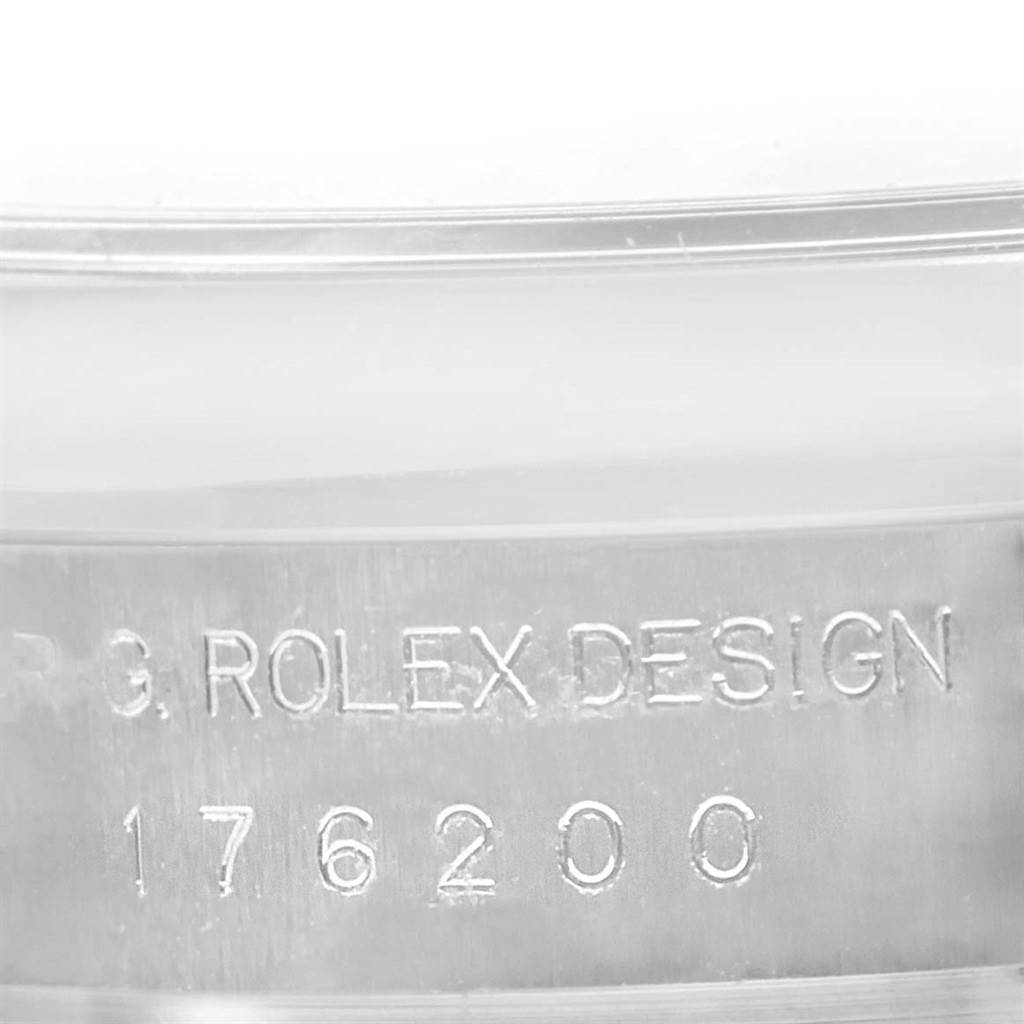 This image shows a close-up of the case side engraving on a Rolex Oyster Perpetual 176200 Women's Stainless Steel White Dial 176200 Women's Stainless Steel White Dial watch, with "ROLEX DESIGN" and serial number "176200."