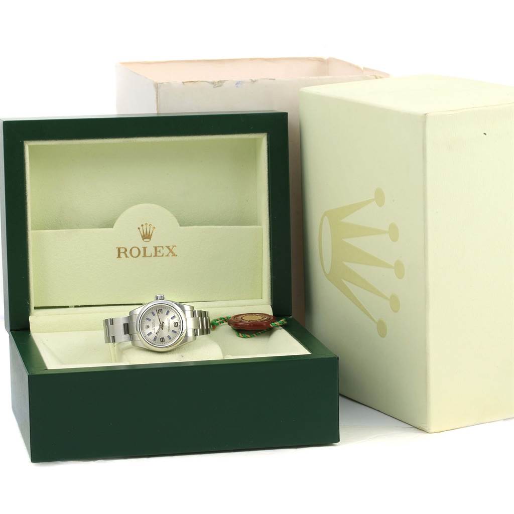 The photo shows a Rolex Oyster Perpetual 176200 Women
s Stainless Steel Silver Dial 176200 Women
s Stainless Steel Silver Dial watch in its open green and cream box with an outer box visible.