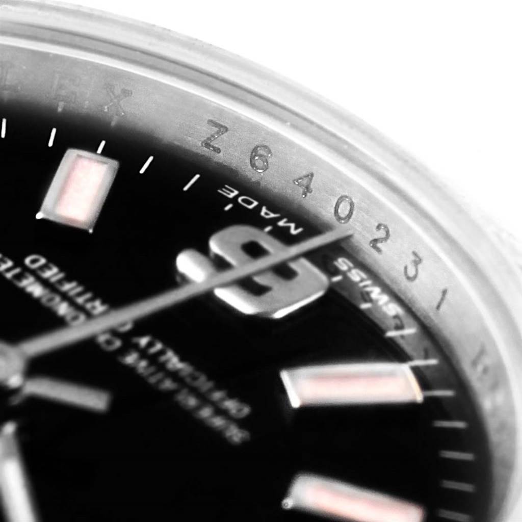 This close-up image of the Rolex Oyster Perpetual 176234 Women
s Stainless Steel Black Dial 176234 Women
s Stainless Steel Black Dial shows part of the dial, the numeral 9, and part of the watch
s rehaut inscribed with a serial number.