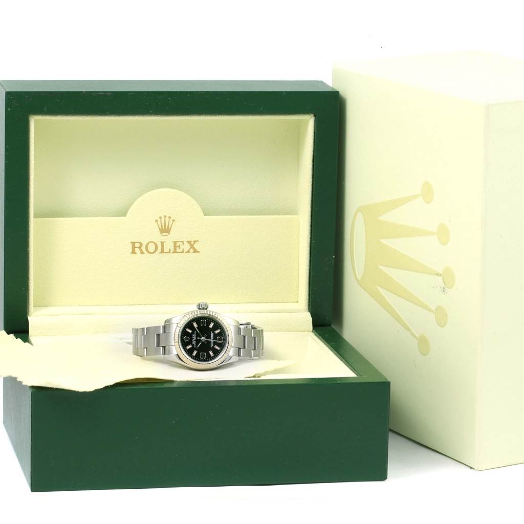 The Rolex Oyster Perpetual 176234 Women
s Stainless Steel Black Dial 176234 Women
s Stainless Steel Black Dial watch is displayed front-on inside its green and beige presentation box with the outer box visible.